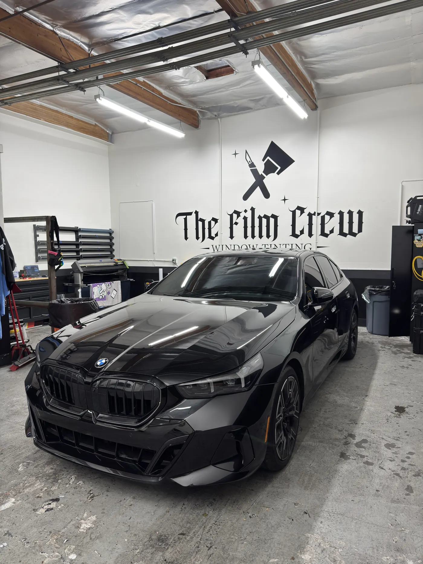 Blue performance sedan with ceramic tint and a deep gloss finish