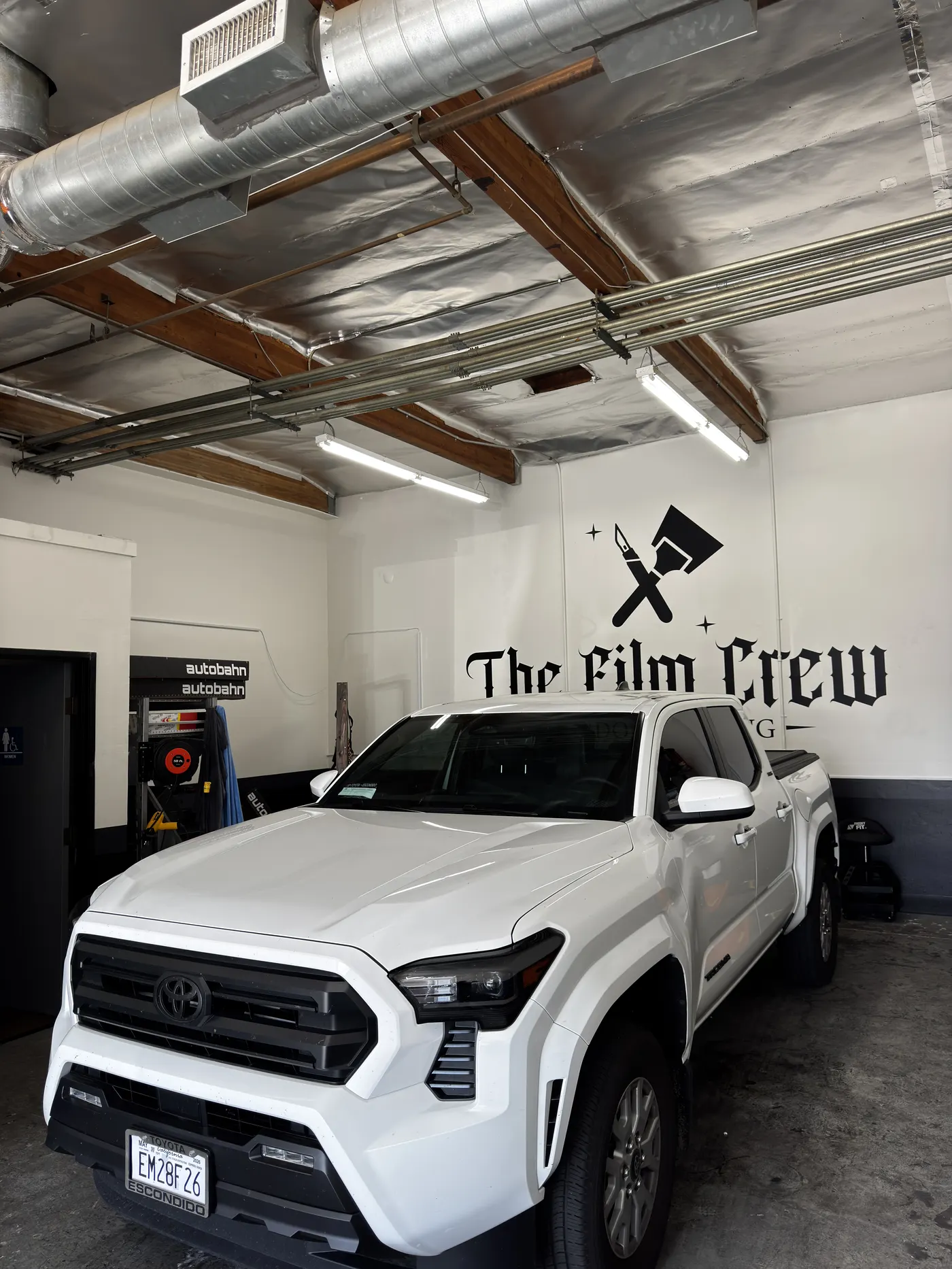 White Tesla Model Y with ceramic window tint at The Film Crew Automotive